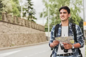 Smiling student holding a map and, symbolizing global journey guided by top study abroad consultants in Kerala.
