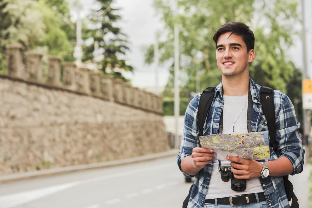 Smiling student holding a map and, symbolizing global journey guided by top study abroad consultants in Kerala.